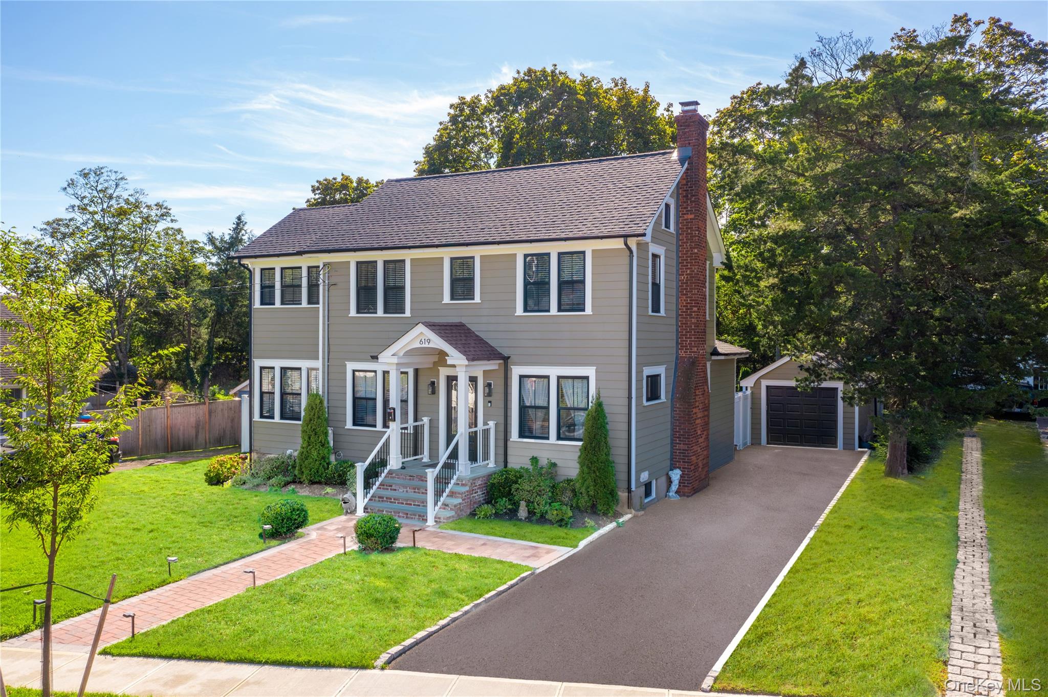 619 Bailey Avenue Greenport, NY 11944 - Photo 1 of 34 Farm House featuring an outdoor structure, a chimney, a garage, asphalt driveway, and roof with shingles