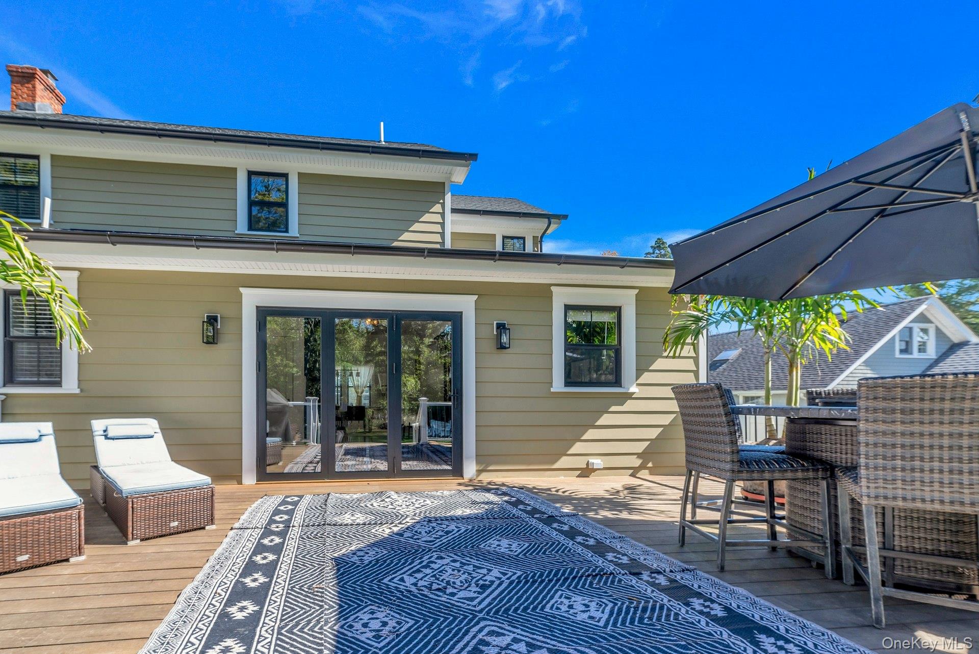 619 Bailey Avenue Greenport, NY 11944 - Photo 23 of 34 Back of house with deck and bifold doors