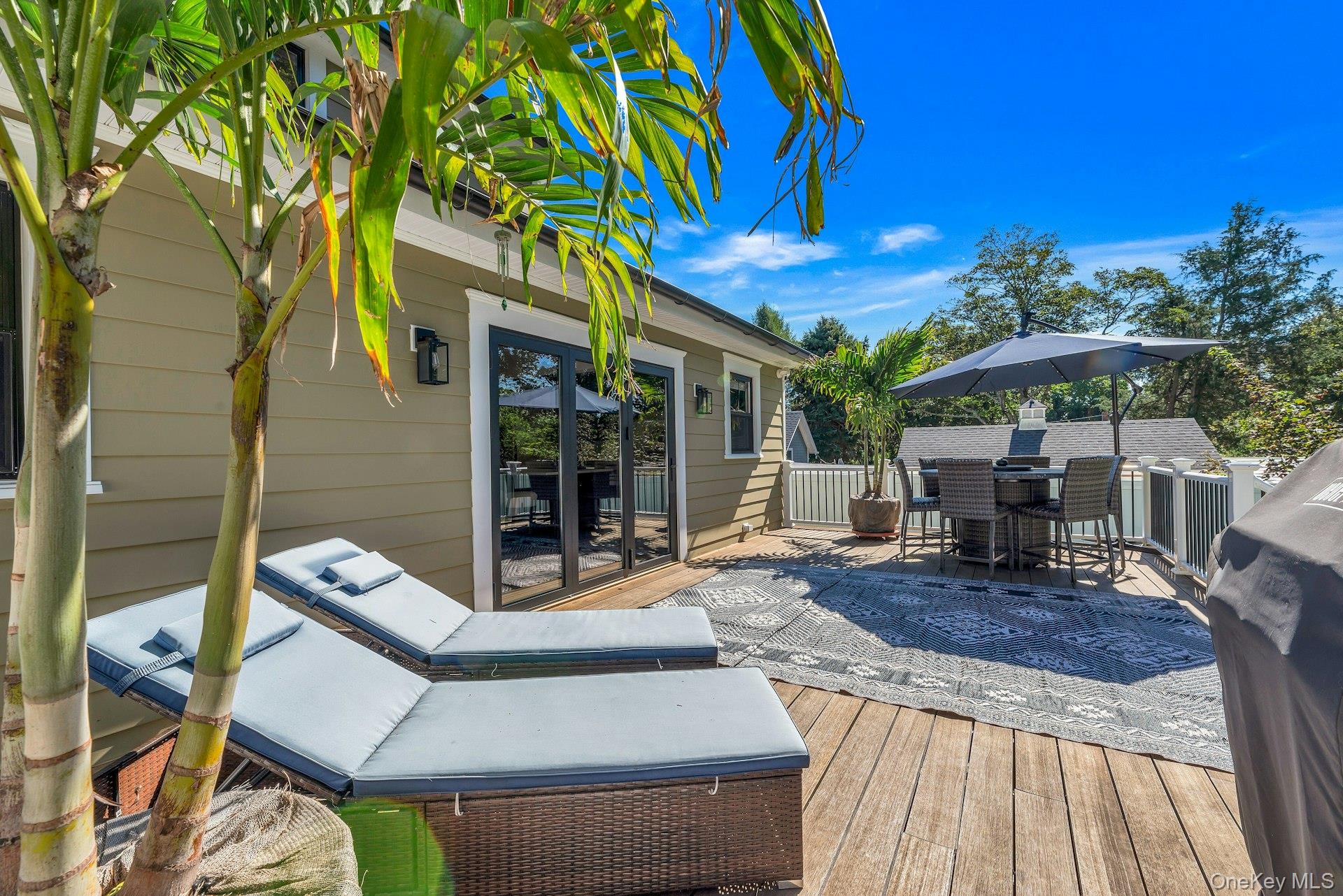 619 Bailey Avenue Greenport, NY 11944 - Photo 24 of 34 Back of house with deck and bifold doors