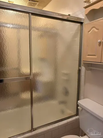 a bathroom with a glass shower door