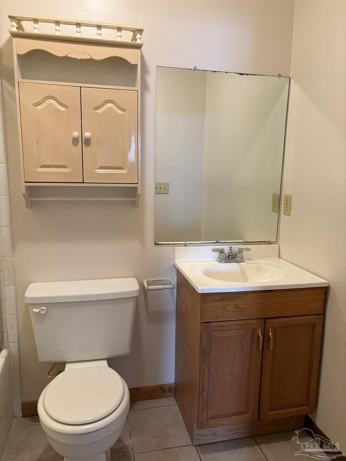 3262 Maplewood Drive, Unit B Gulf Breeze, FL 32563 - Photo 12 of 15 a bathroom with a toilet a sink and mirror