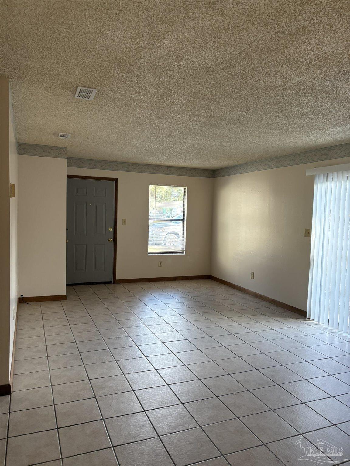 3262 Maplewood Drive, Unit B Gulf Breeze, FL 32563 - Photo 4 of 15 an empty room with windows