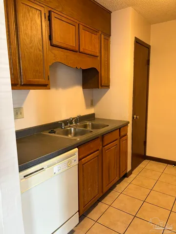 a kitchen with granite countertop cabinets and appliances