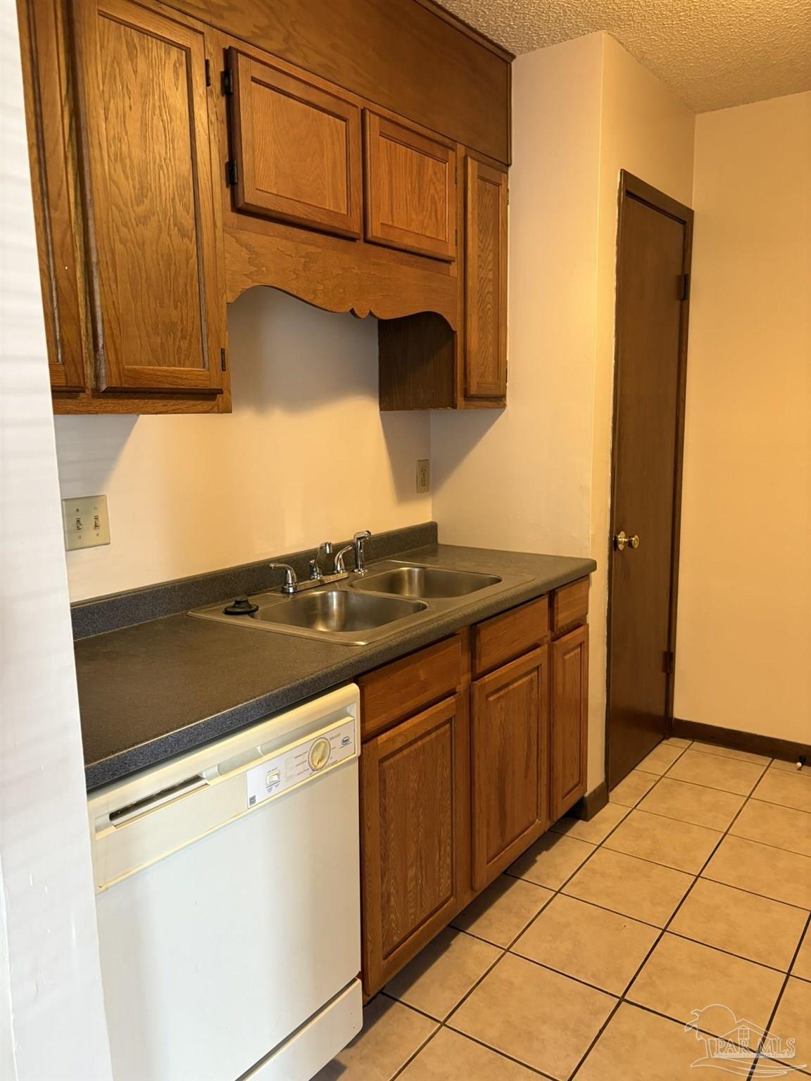 3262 Maplewood Drive, Unit B Gulf Breeze, FL 32563 - Photo 6 of 15 a kitchen with granite countertop cabinets and appliances