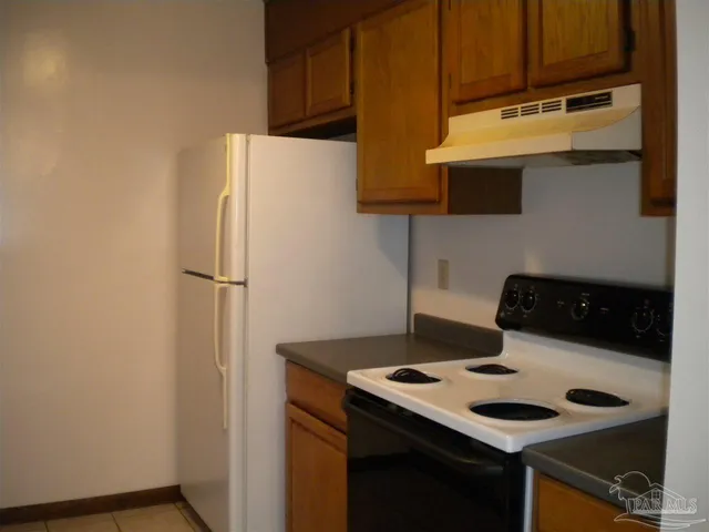 a kitchen with a refrigerator a stove and a sink