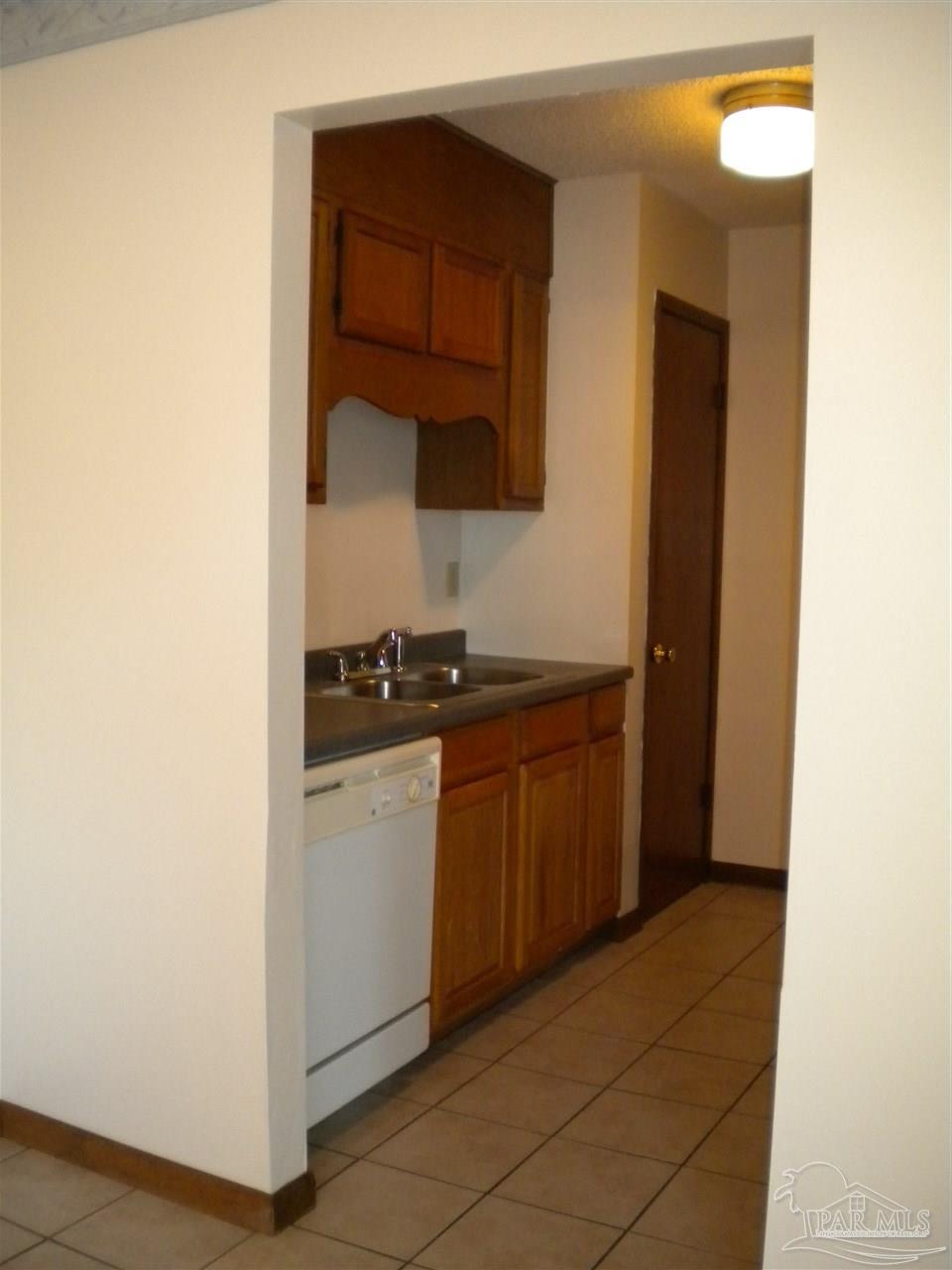 3262 Maplewood Drive, Unit B Gulf Breeze, FL 32563 - Photo 8 of 15 a kitchen with stainless steel appliances granite countertop a sink and a stove with wooden floor