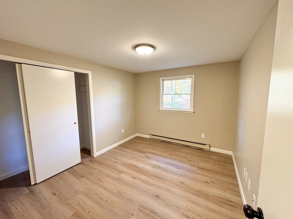 201 Pierce Road West Brookfield, MA 01585 - Photo 11 of 27 an empty room with wooden floor and windows