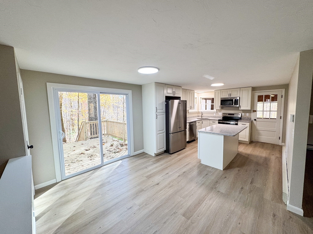 201 Pierce Road West Brookfield, MA 01585 - Photo 5 of 27 a view of a kitchen with refrigerator and wooden floor