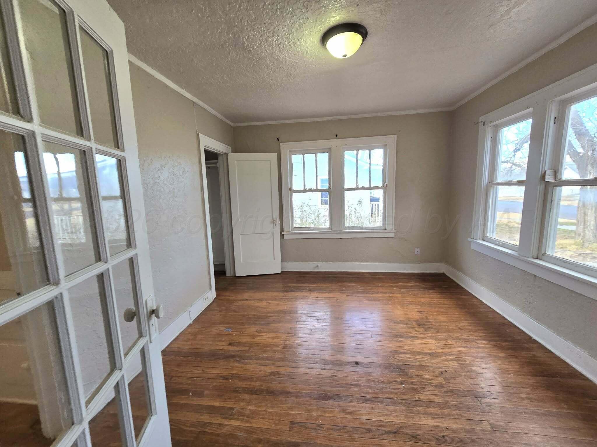 2706 Ridgemere Boulevard Amarillo, TX 79107 - Photo 13 of 49 an empty room with wooden floor and windows