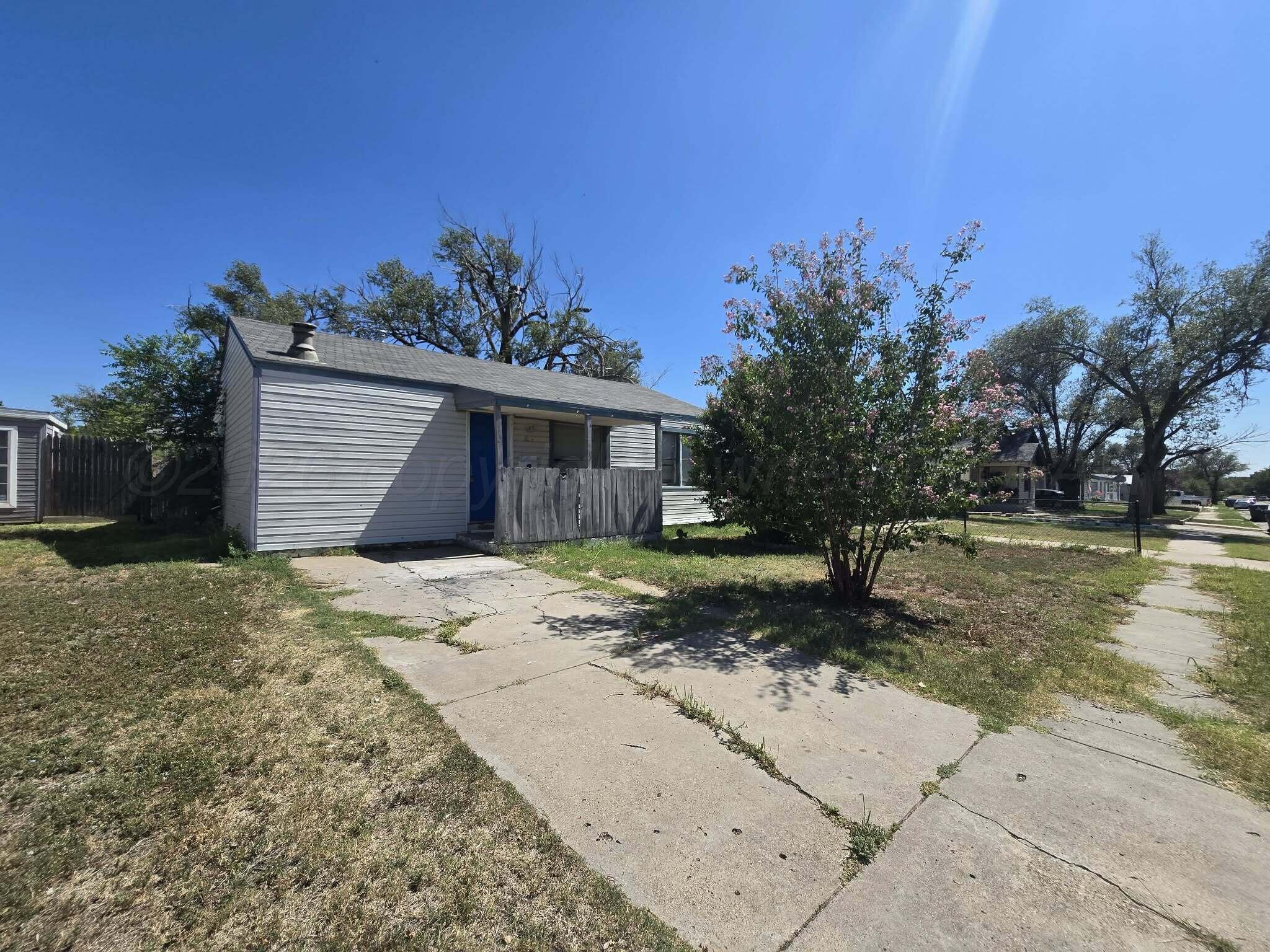 2706 Ridgemere Boulevard Amarillo, TX 79107 - Photo 19 of 49 a front view of a house with a yard and garage