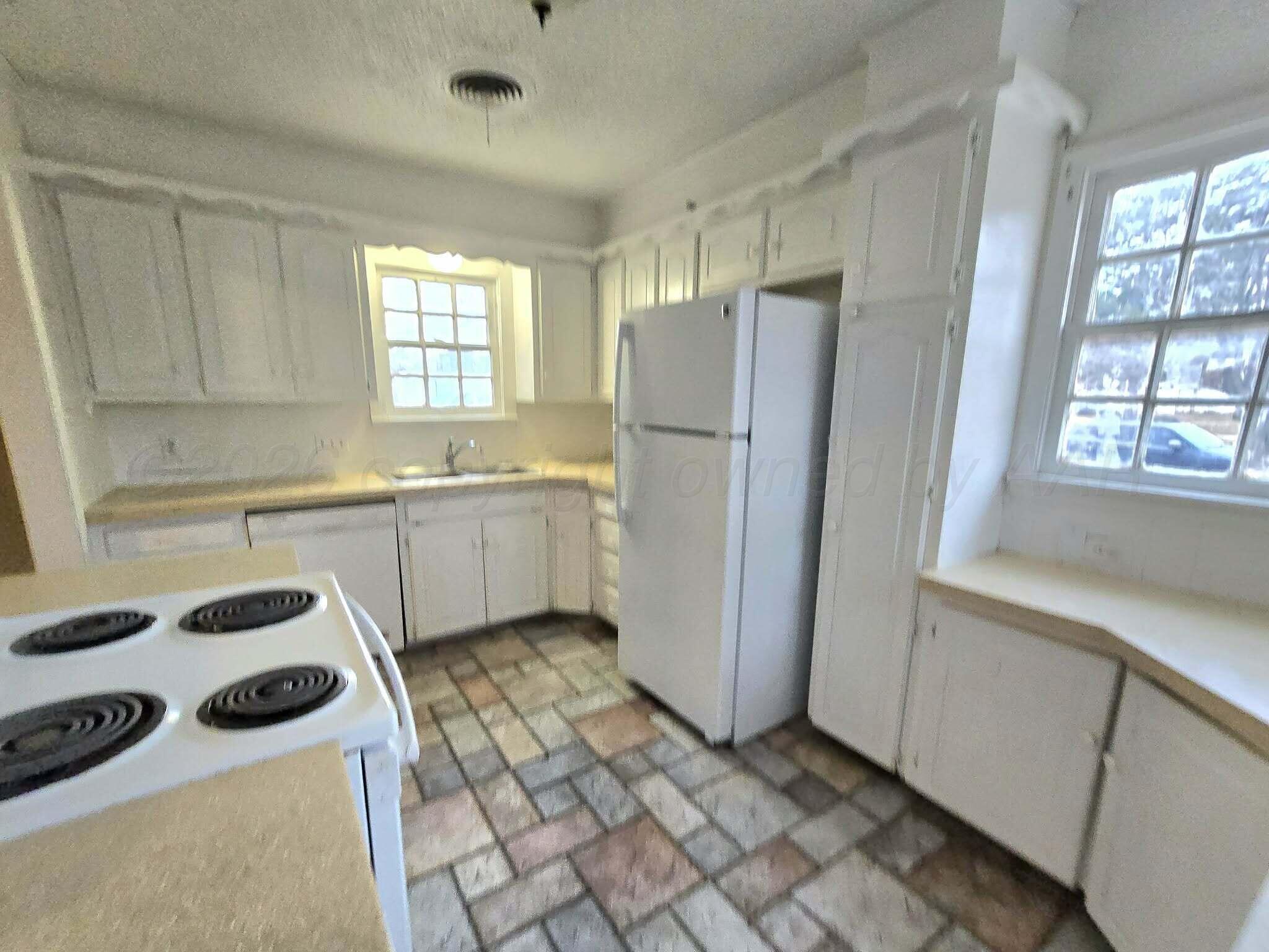 2706 Ridgemere Boulevard Amarillo, TX 79107 - Photo 21 of 49 a kitchen with a refrigerator a sink and a window