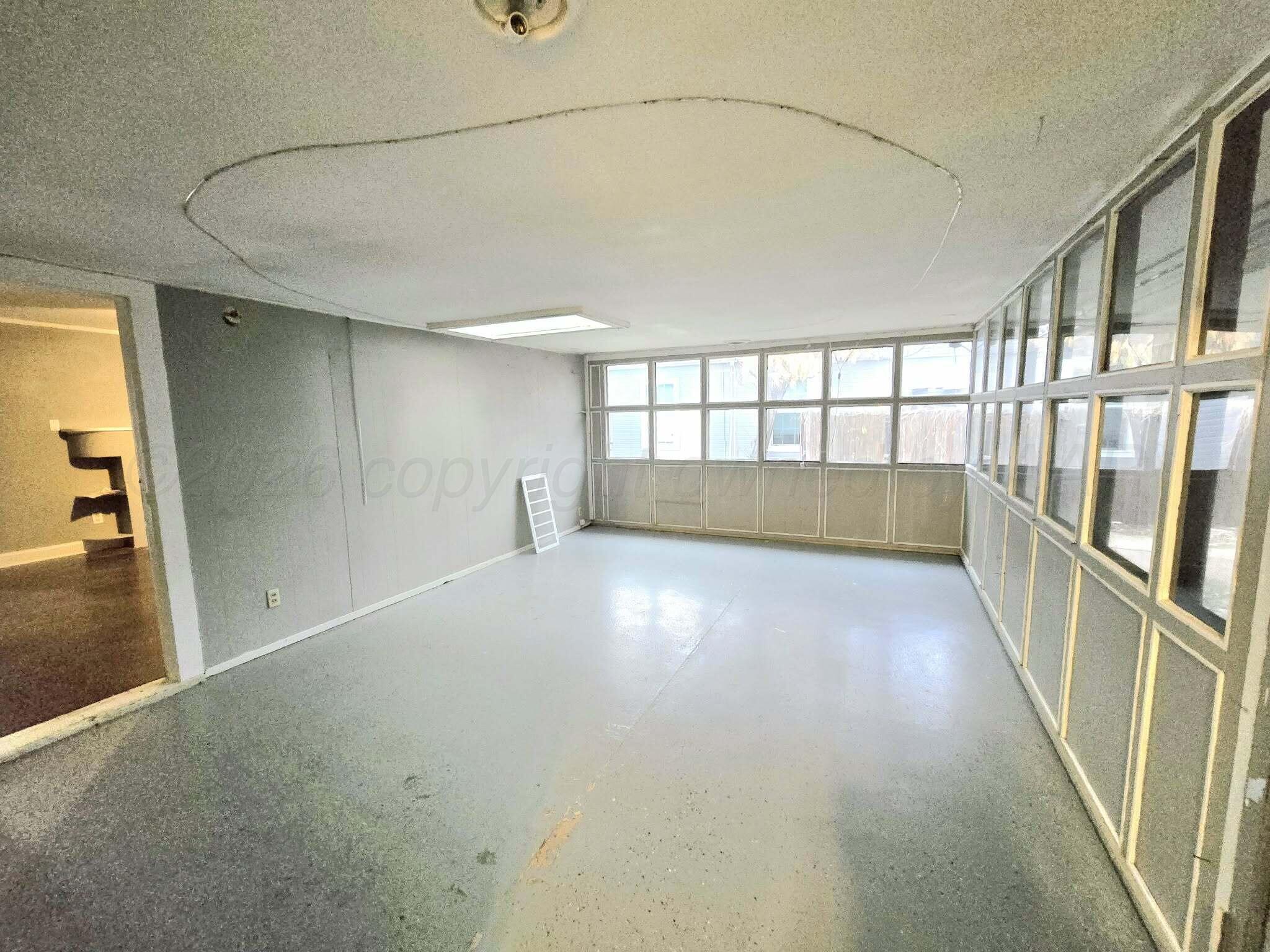 2706 Ridgemere Boulevard Amarillo, TX 79107 - Photo 23 of 49 an empty room with windows