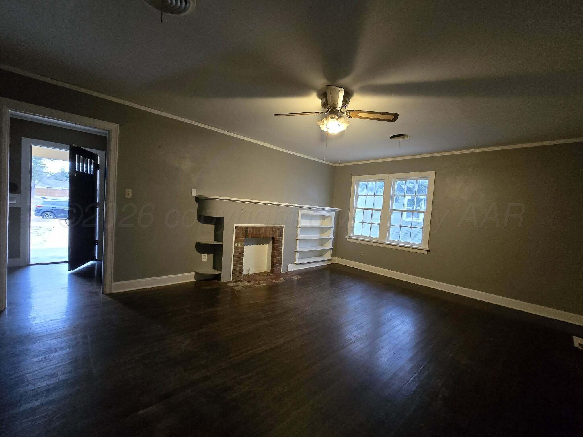 2706 Ridgemere Boulevard Amarillo, TX 79107 - Photo 24 of 49 a view of an empty room with wooden floor and a window