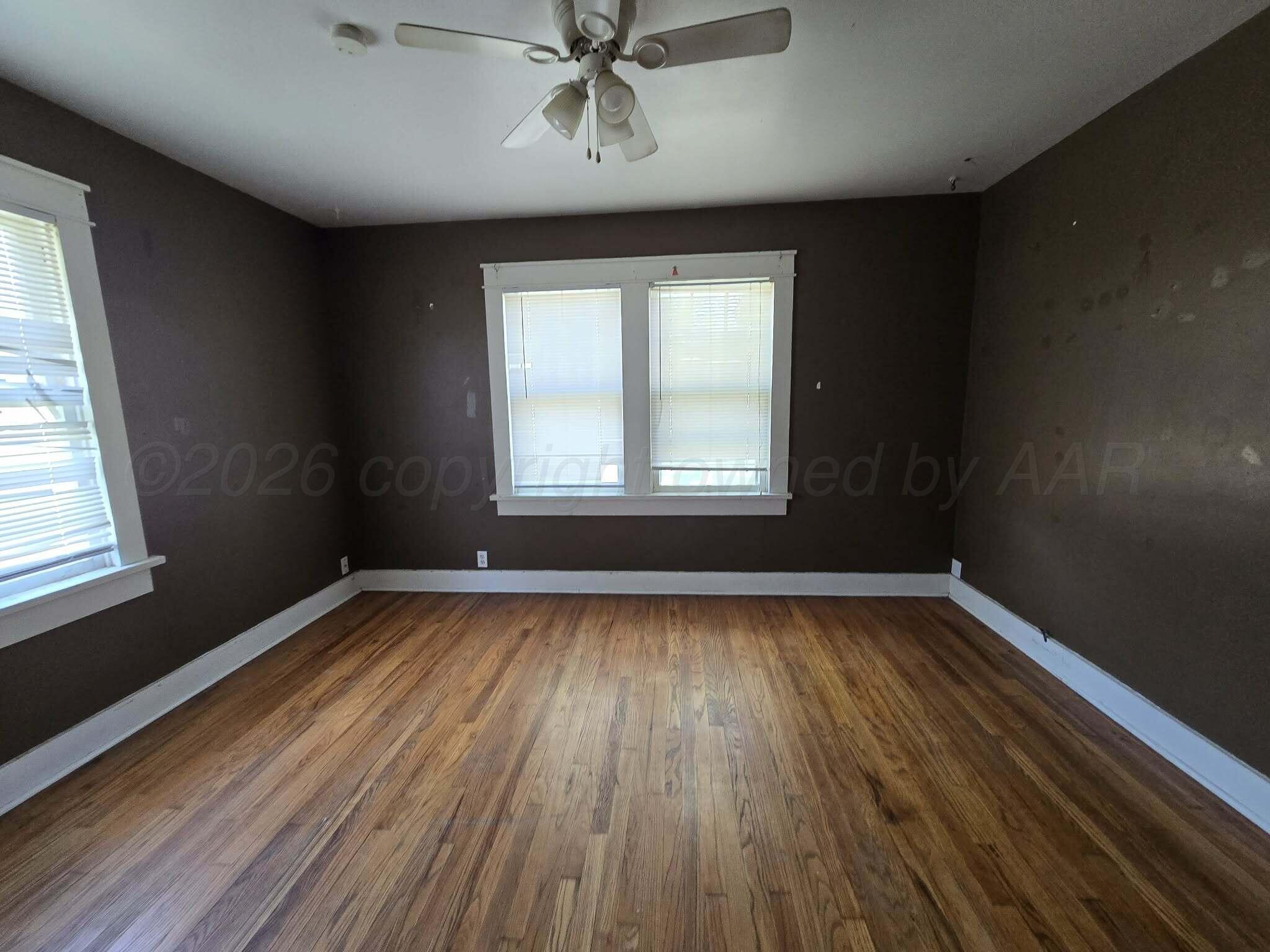2706 Ridgemere Boulevard Amarillo, TX 79107 - Photo 25 of 49 a view of an empty room with wooden floor and a window