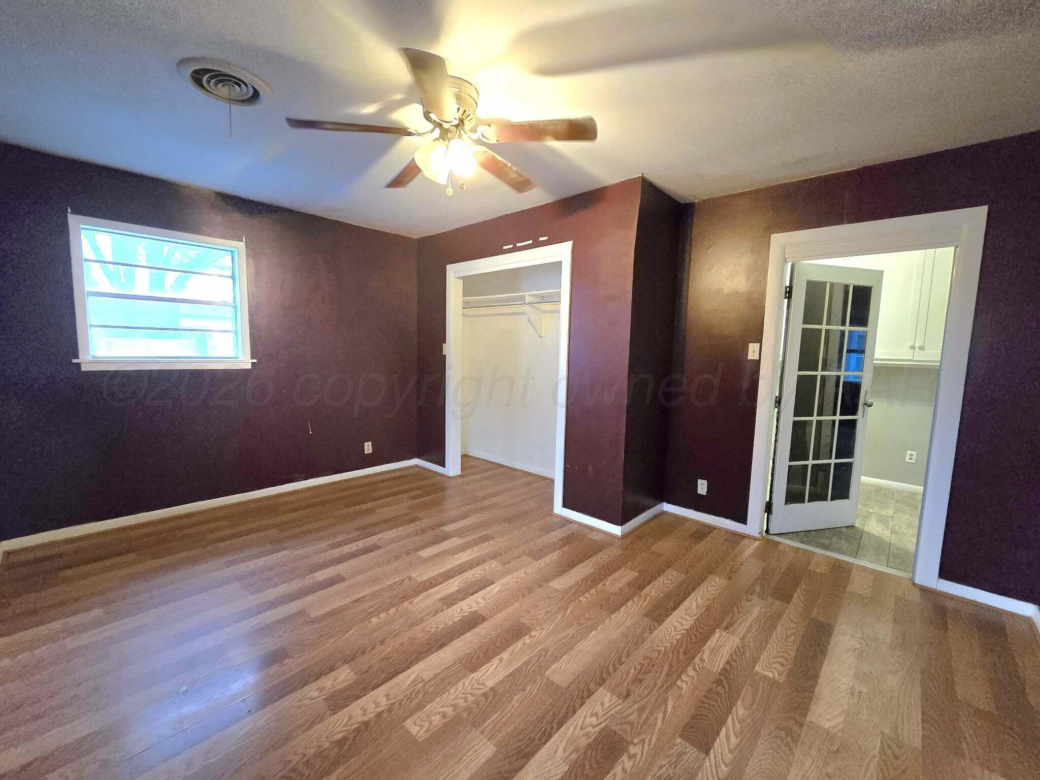 2706 Ridgemere Boulevard Amarillo, TX 79107 - Photo 26 of 49 a view of an empty room with wooden floor and a window