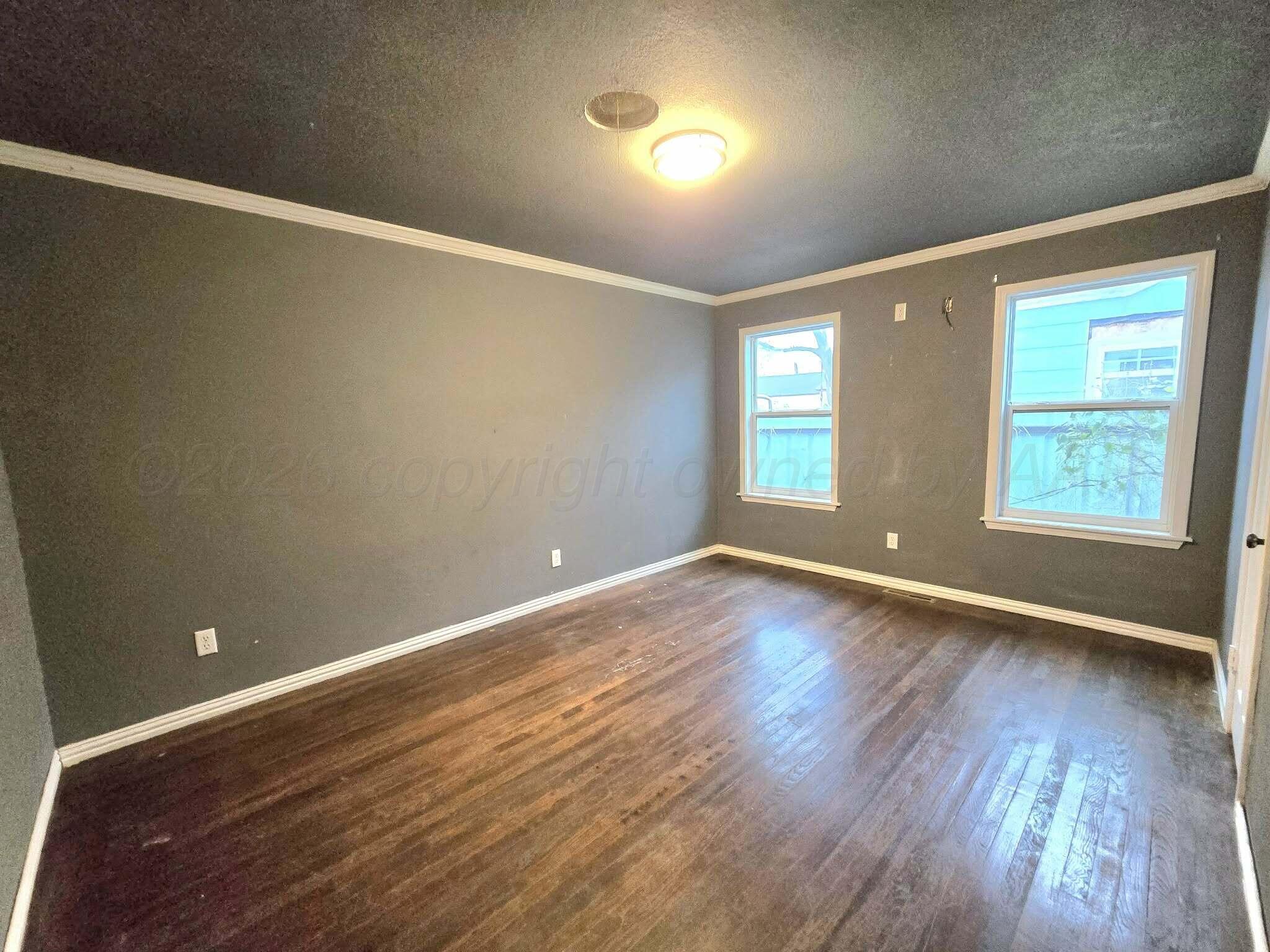 2706 Ridgemere Boulevard Amarillo, TX 79107 - Photo 27 of 49 an empty room with wooden floor and windows