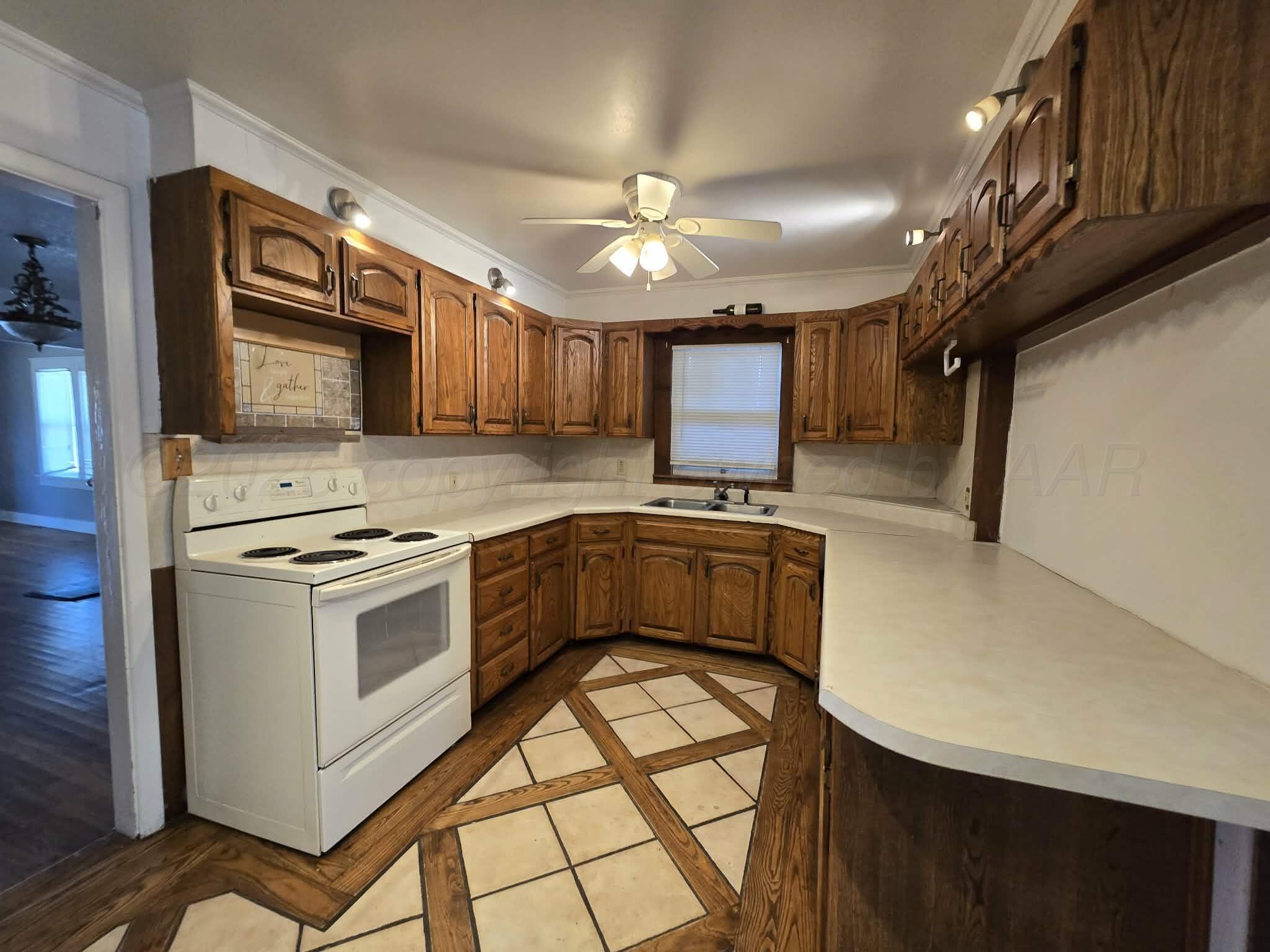 2706 Ridgemere Boulevard Amarillo, TX 79107 - Photo 3 of 49 a kitchen with cabinets a window and stainless steel appliances