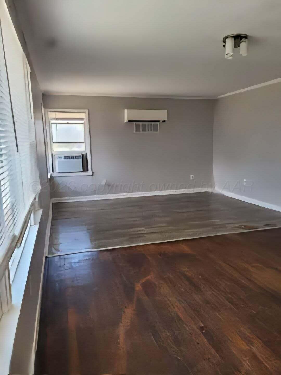 2706 Ridgemere Boulevard Amarillo, TX 79107 - Photo 39 of 49 an empty room with wooden floor and windows