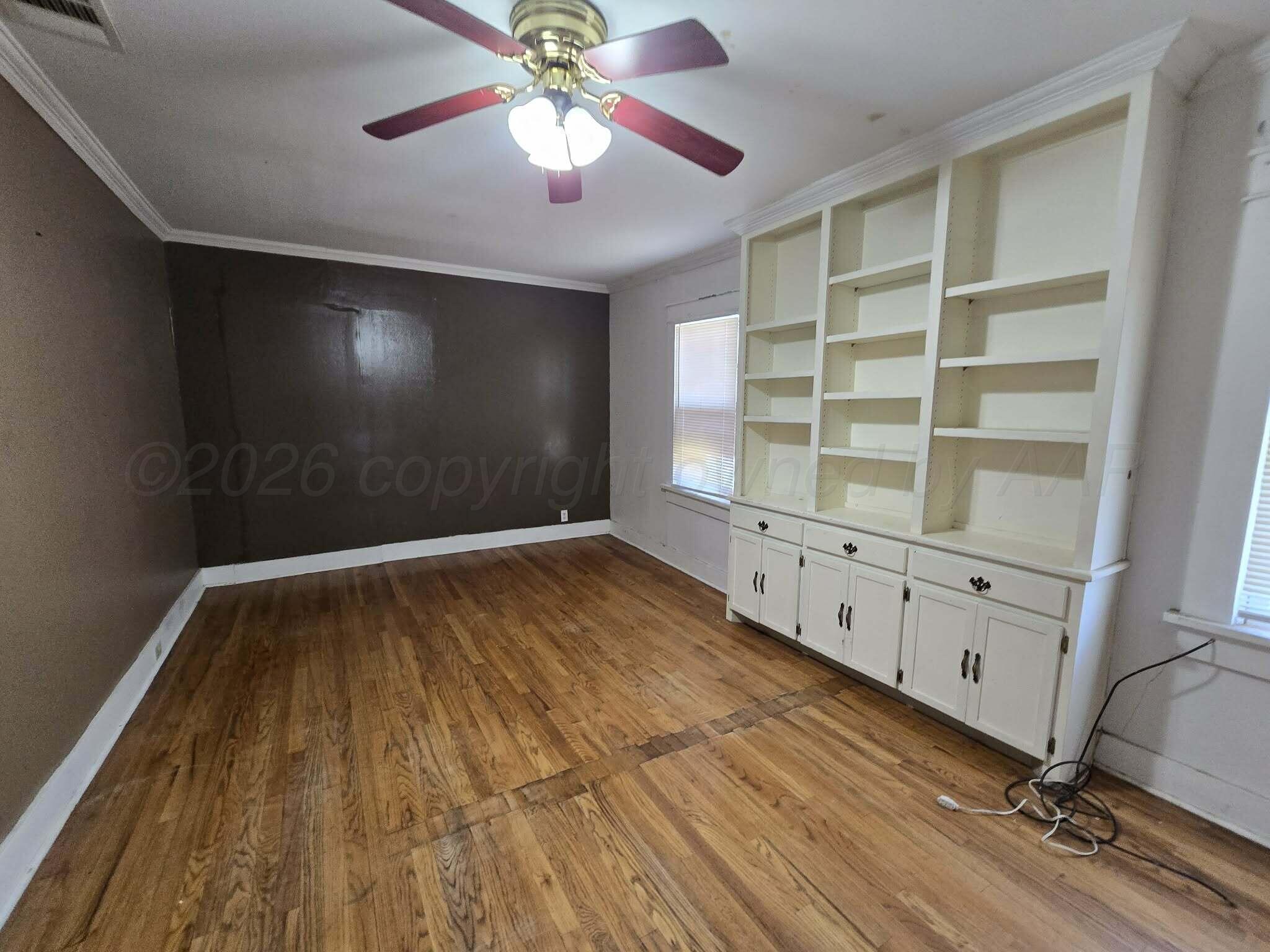 2706 Ridgemere Boulevard Amarillo, TX 79107 - Photo 4 of 49 wooden floor in an empty room with a window