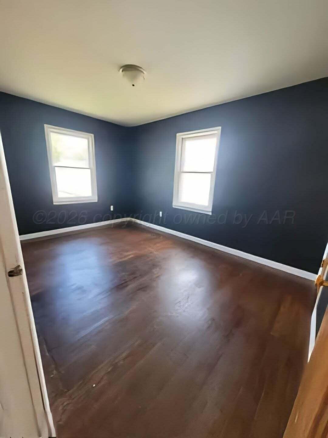 2706 Ridgemere Boulevard Amarillo, TX 79107 - Photo 41 of 49 an empty room with wooden floor and windows
