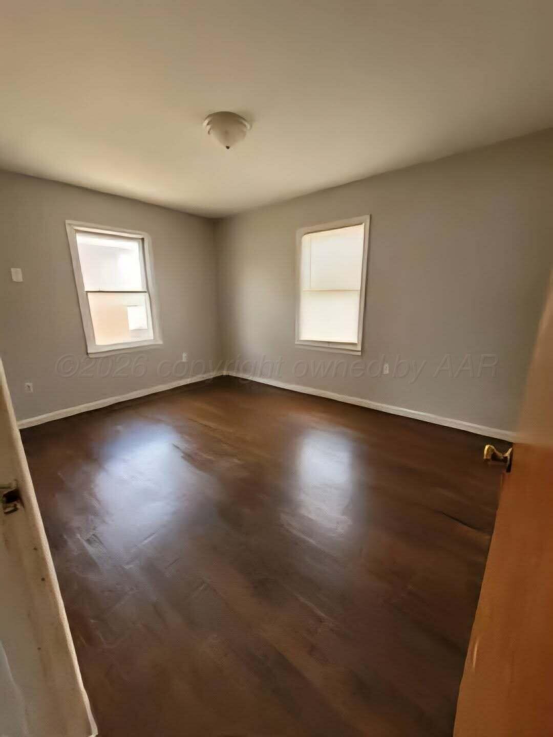 2706 Ridgemere Boulevard Amarillo, TX 79107 - Photo 42 of 49 an empty room with wooden floor and windows