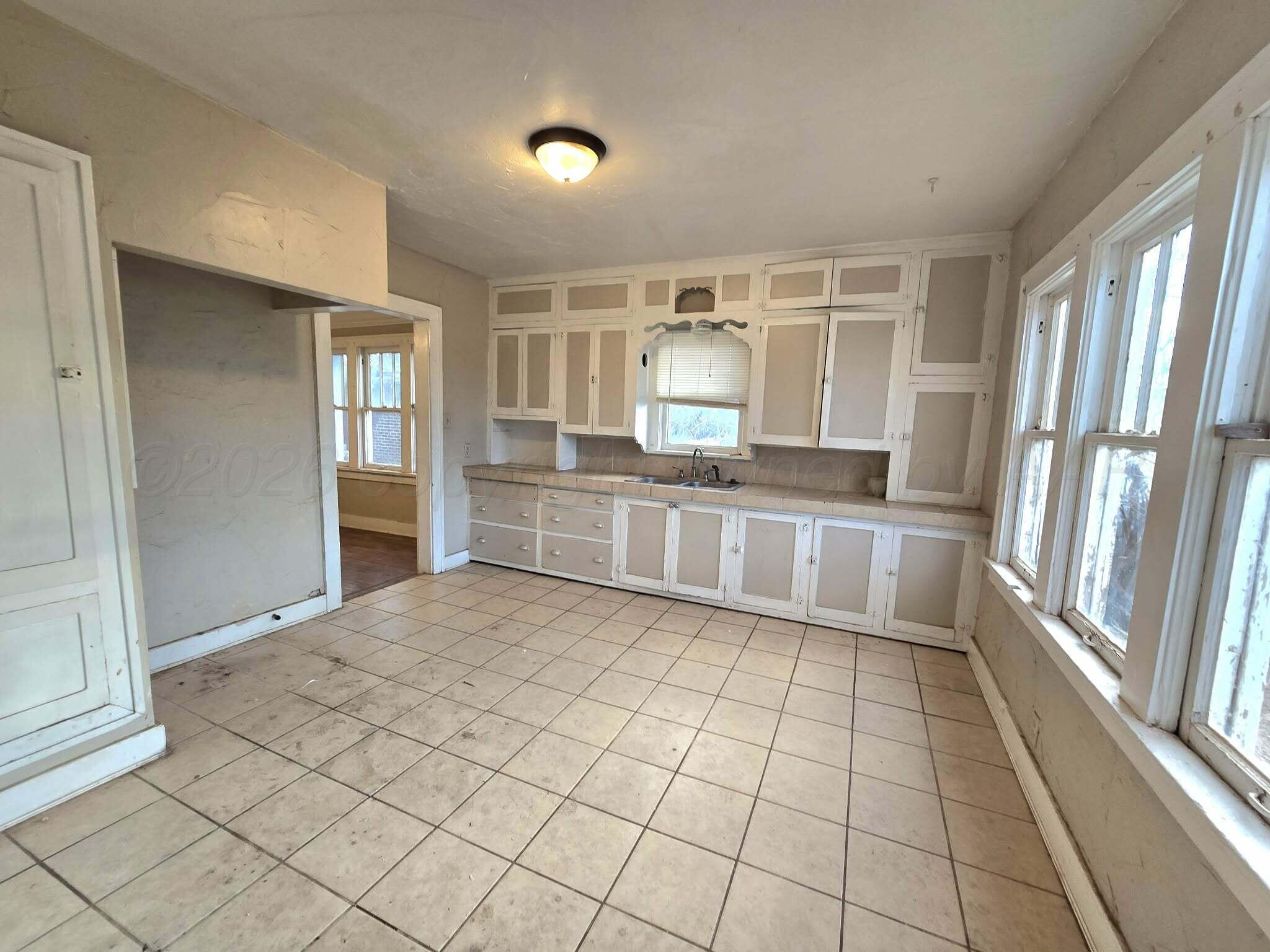 2706 Ridgemere Boulevard Amarillo, TX 79107 - Photo 7 of 49 a kitchen with granite countertop a sink and a stove top oven