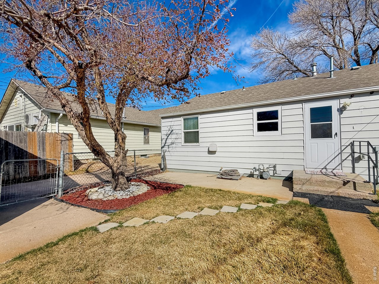 525 Cleveland Street Sterling, CO 80751 - Photo 28 of 35 Back patio with shade tree