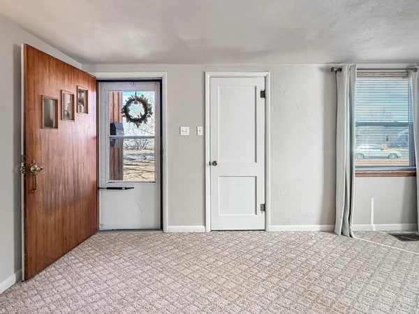 a view of an empty room and closet area