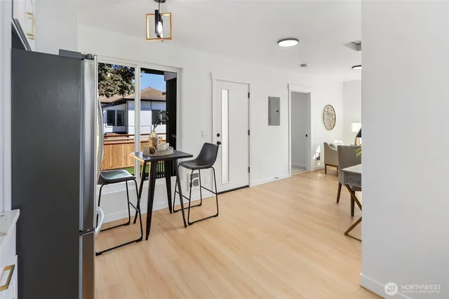 a living room with furniture a large window and potted plants