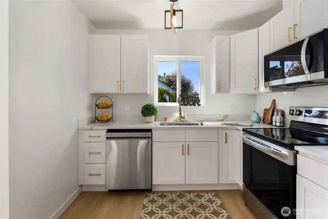 a kitchen with stainless steel appliances granite countertop a refrigerator stove a sink and a microwave