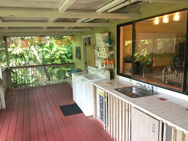 a kitchen view with wooden floor and outdoor space