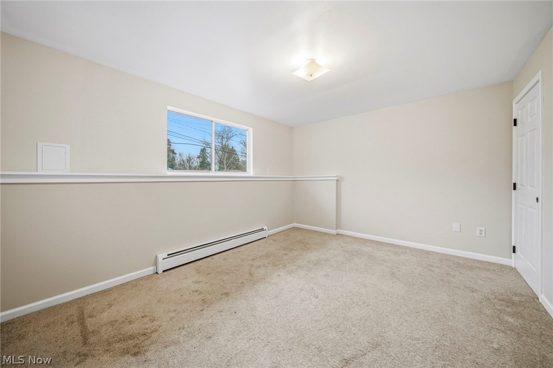 10397 Prouty Road Painesville, OH 44077 - Photo 20 of 32 Carpeted empty room with baseboard heating and baseboards
