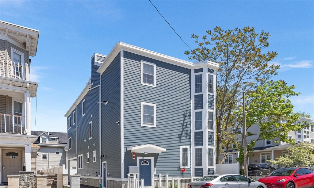 128 Hamilton Street, Unit 2B Boston, MA 02125 - Photo 1 of 23 a front view of a building with a tree