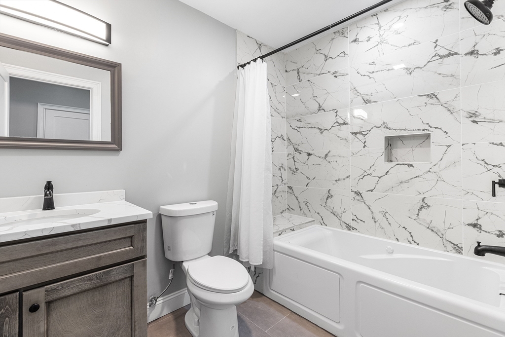 128 Hamilton Street, Unit 2B Boston, MA 02125 - Photo 15 of 23 a bathroom with a bathtub and a toilet