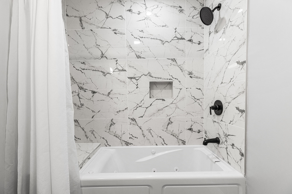 128 Hamilton Street, Unit 2B Boston, MA 02125 - Photo 16 of 23 a bathroom with a bathtub and shower