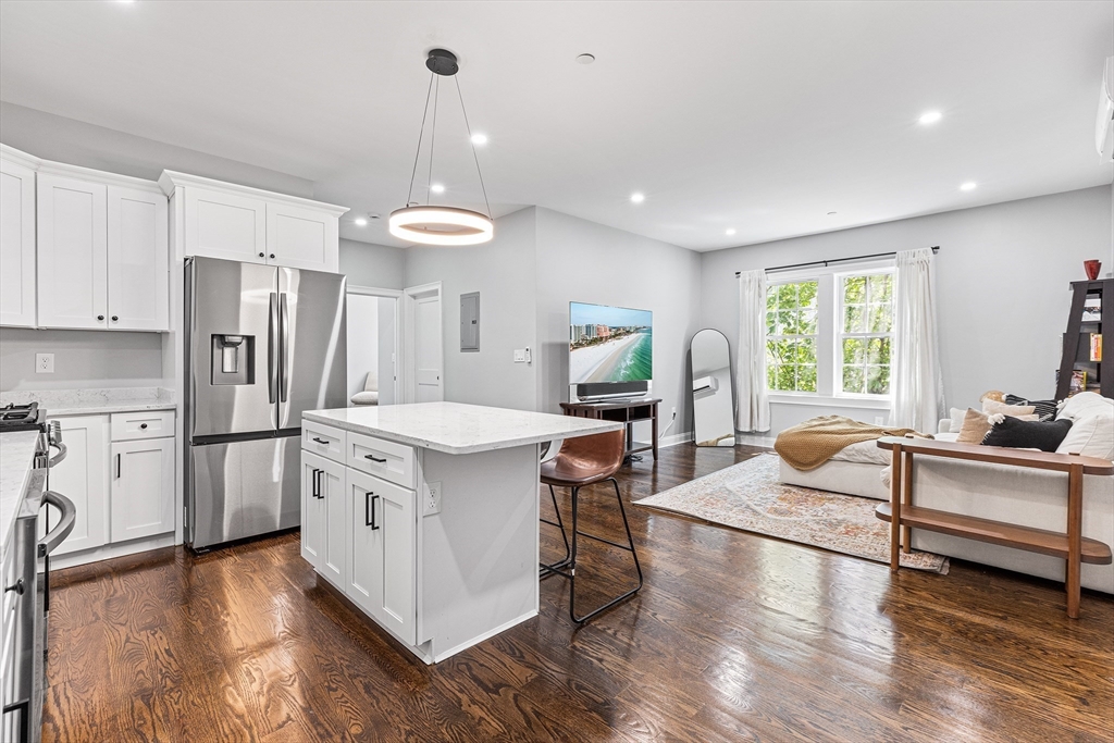 128 Hamilton Street, Unit 2B Boston, MA 02125 - Photo 6 of 23 a kitchen with stainless steel appliances granite countertop a stove refrigerator and cabinets