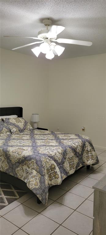 2218 Abbey Road Southwest Winter Haven, FL 33880 - Photo 12 of 31 a bedroom with a bed and chandelier