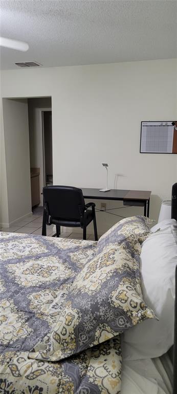 2218 Abbey Road Southwest Winter Haven, FL 33880 - Photo 13 of 31 a bedroom with a bed and a lamp