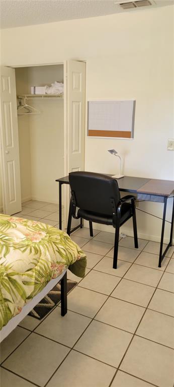 2218 Abbey Road Southwest Winter Haven, FL 33880 - Photo 18 of 31 a bedroom with a bed and a table