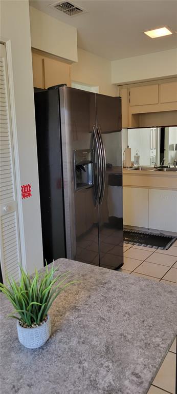 2218 Abbey Road Southwest Winter Haven, FL 33880 - Photo 5 of 31 a kitchen with stainless steel appliances kitchen island granite countertop a refrigerator a stove and a sink