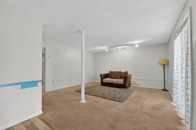 a living room with furniture and a ceiling fan