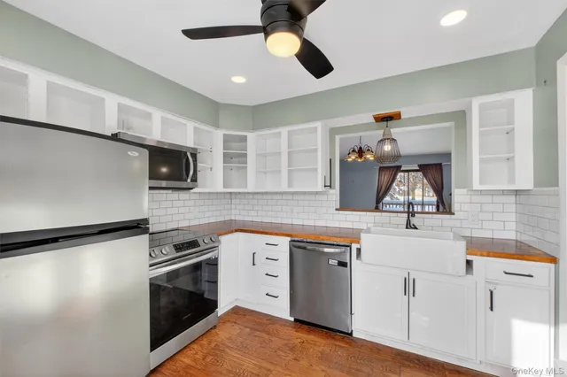 a kitchen with stainless steel appliances granite countertop a sink and a stove
