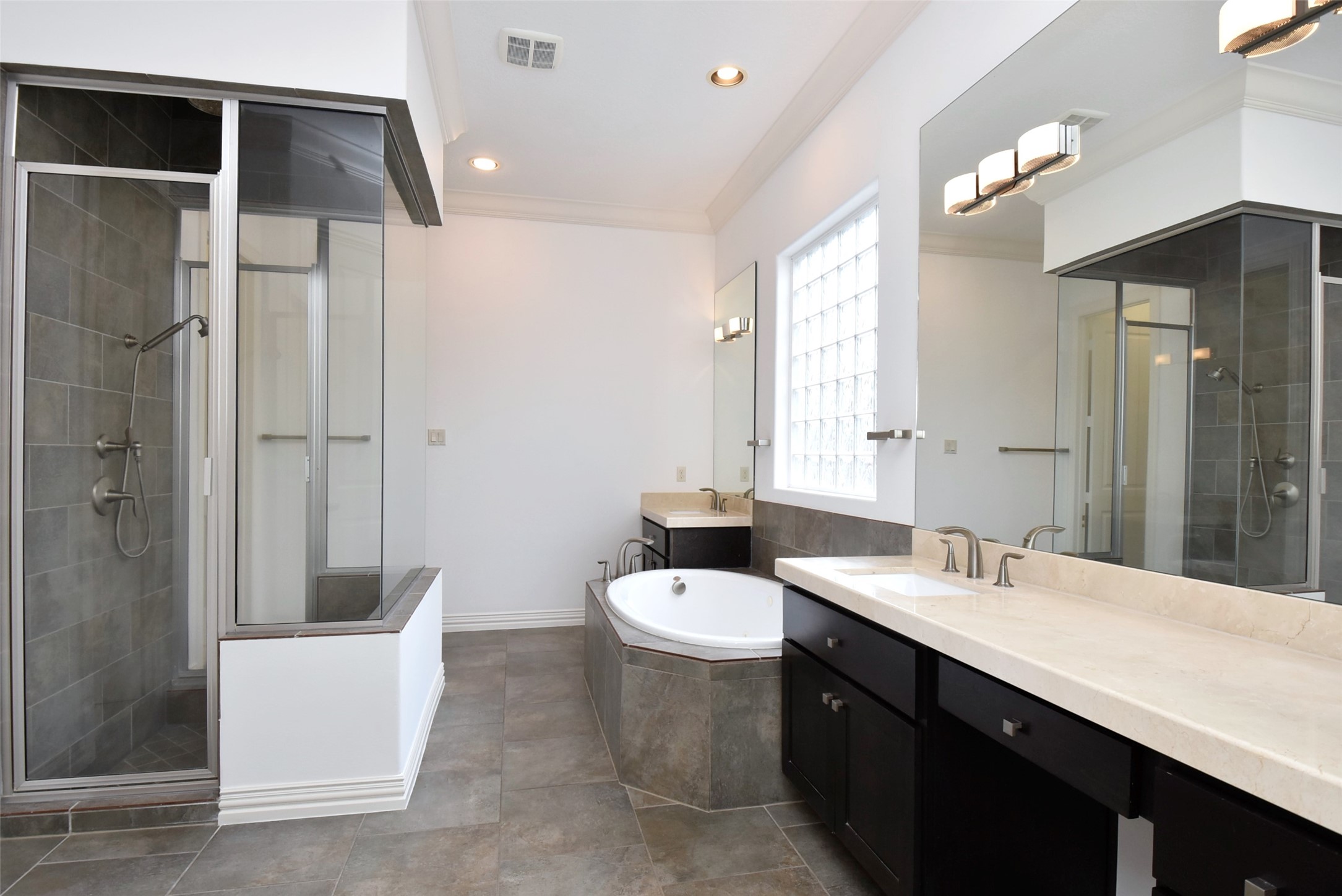 2014 Split Branch Court Houston, TX 77077 - Photo 15 of 47 a bathroom with a double vanity sink a toilet a mirror and shower