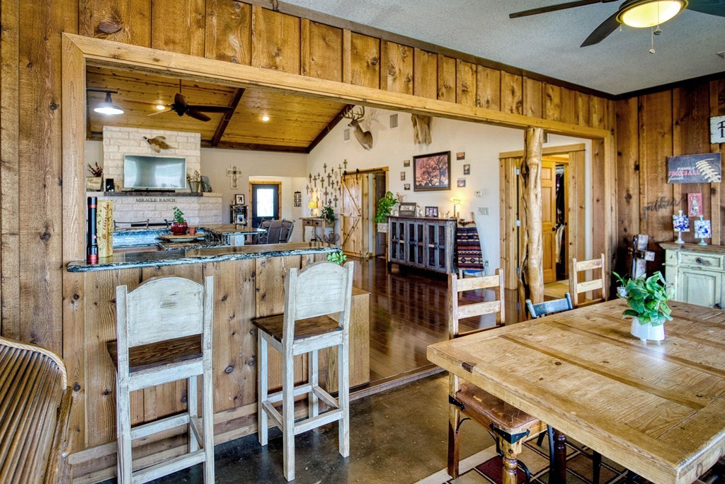 6446 Blackjack Road Fredonia, TX 76842 - Photo 17 of 48 a dining hall with stainless steel appliances granite countertop a dining table and chairs with wooden floor