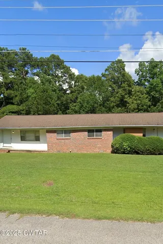 a view of yard with swimming pool and green space