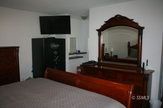 312 West Perdew Avenue Ridgecrest, CA 93555 - Photo 16 of 28 a bedroom with a bed and a television in it