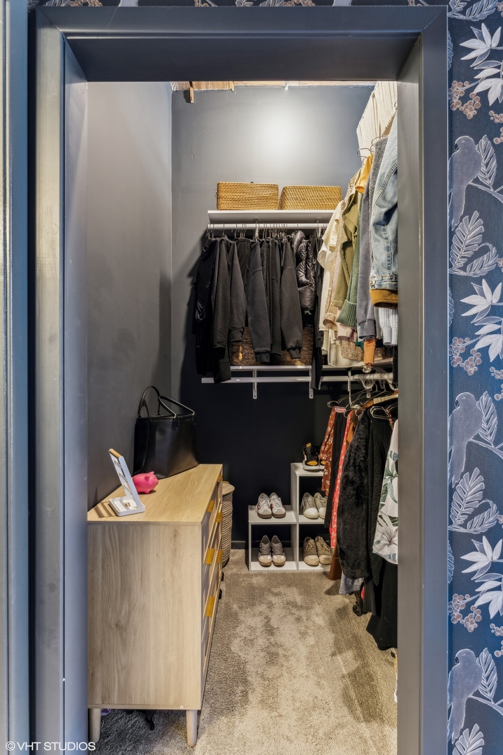 1040 West Adams Street, Unit 308 Chicago, IL 60607 - Photo 20 of 40 a view of walk in closet with clothes and shoes