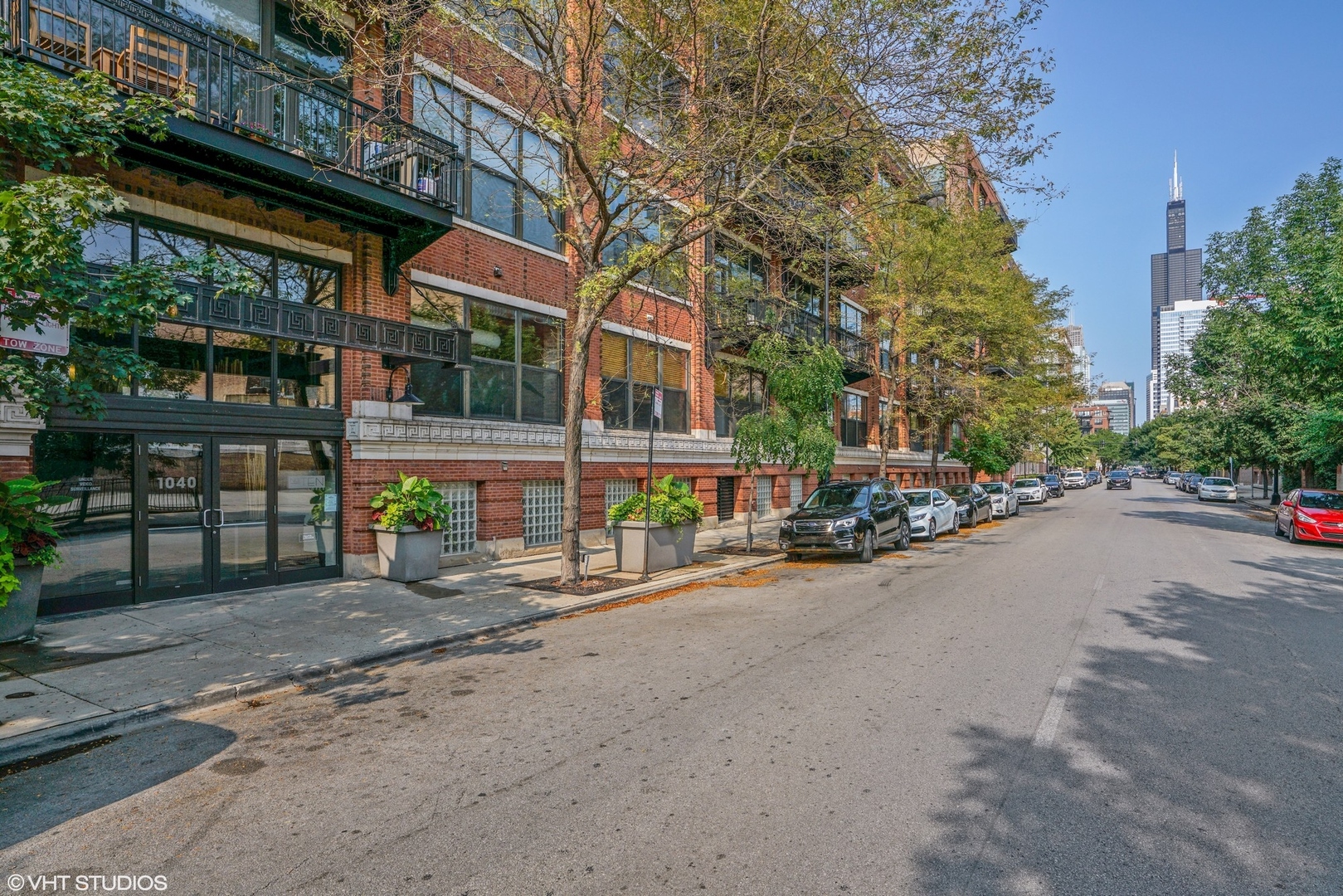 1040 West Adams Street, Unit 308 Chicago, IL 60607 - Photo 2 of 40 a front view of a house with a garden