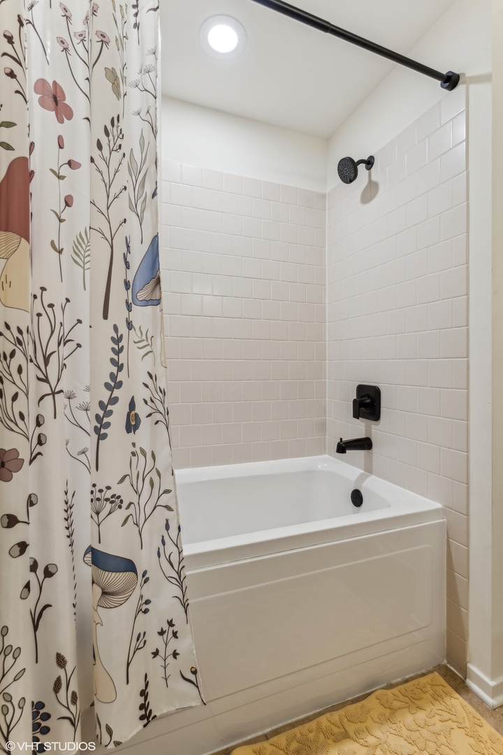 1040 West Adams Street, Unit 308 Chicago, IL 60607 - Photo 26 of 40 a bathroom with a bathtub and shower