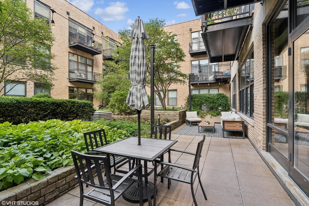 1040 West Adams Street, Unit 308 Chicago, IL 60607 - Photo 35 of 40 a view of a patio with table and chairs and potted plants